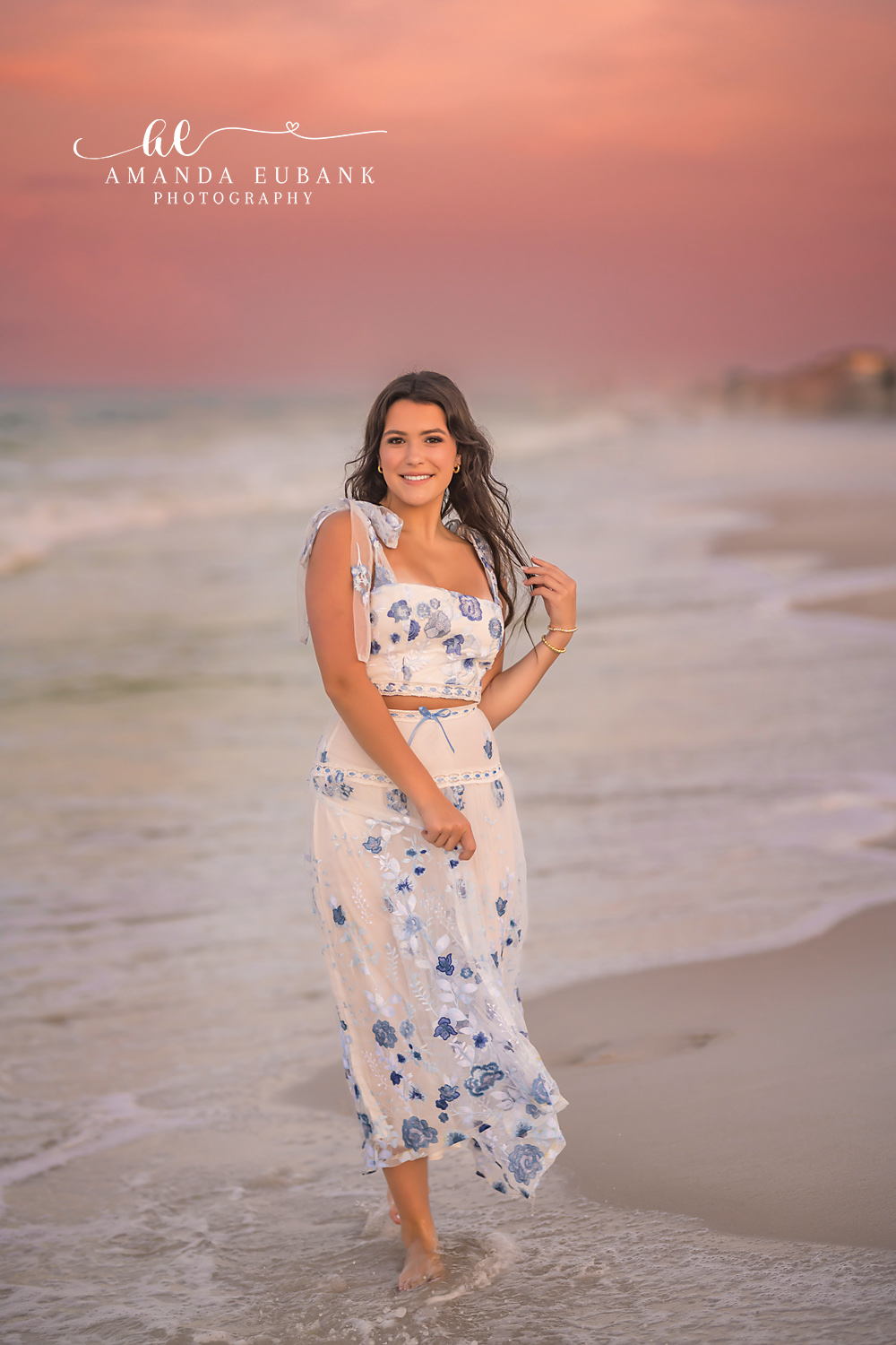 Floral Maxi at the Water’s Edge | Tampa Senior Photographer A senior in a floral maxi dress at the water's edge in soft pink light during a senior portrait session in Tampa, Florida.