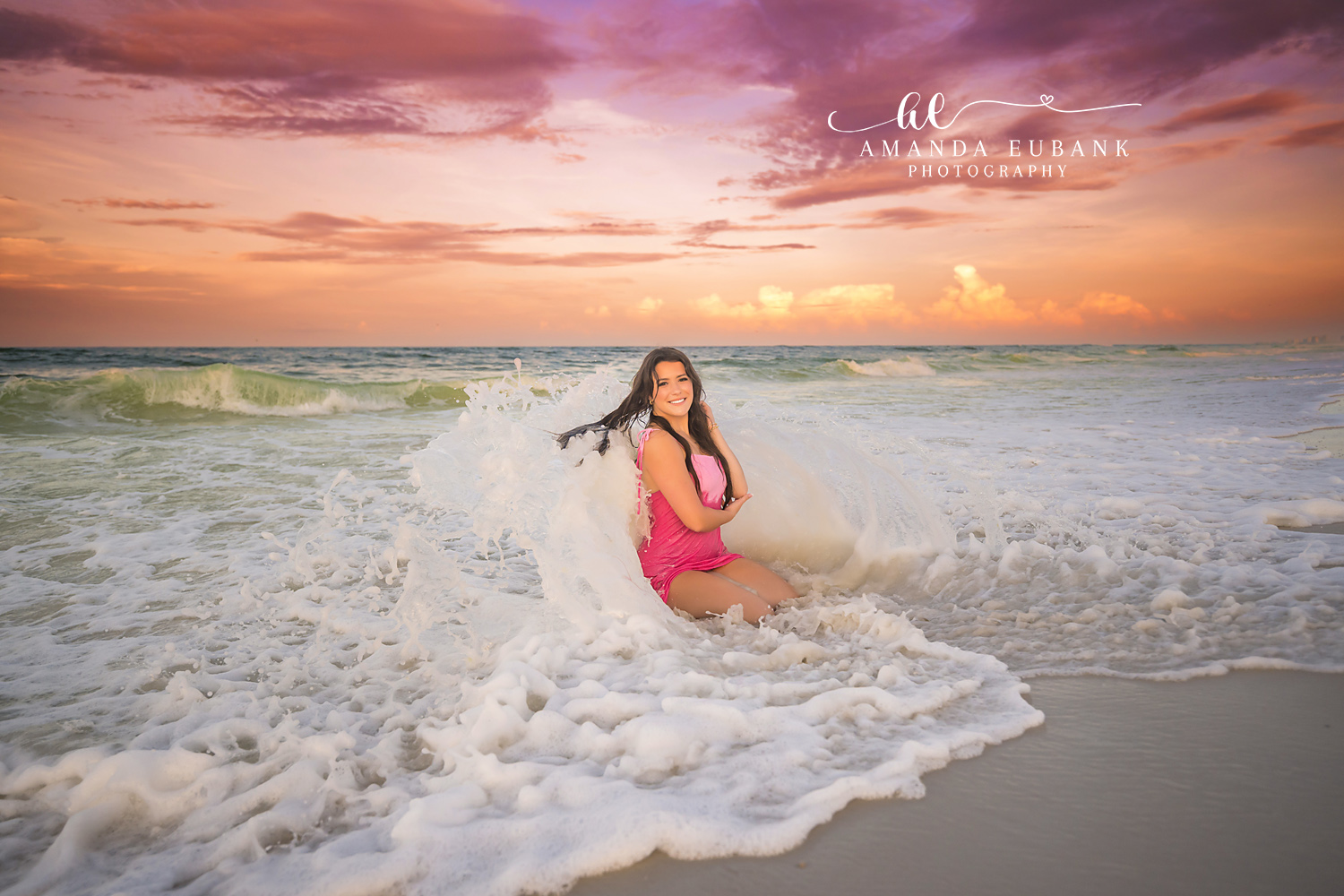 Pink Swimsuit in the Foam | Senior Portraits in Tampa, FL Tampa senior photographer captures a senior in a pink swimsuit seated in rushing sea foam at sunset.
