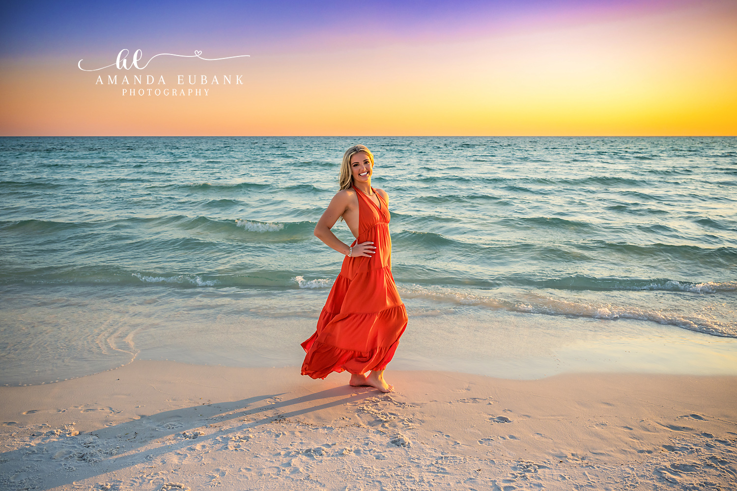 Red Gown by the Turquoise Gulf | Tampa Senior Photographer A senior in a red gown on the wet sand beside the turquoise Gulf during a senior portrait session in Tampa, Florida.