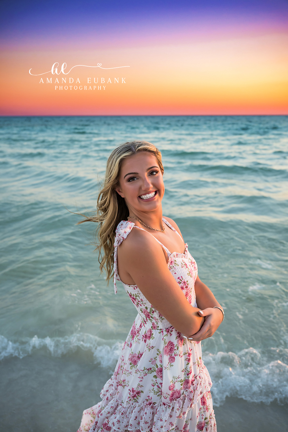 Floral Gown Close Portrait | Tampa Senior Photographer A close portrait of a senior in a floral gown with the Gulf and dusk sky behind during a senior portrait session in Tampa, Florida.