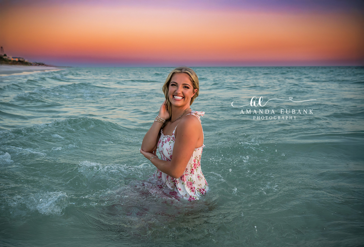 Waves Around Her Knees — Tampa Bay Senior Photography A senior in a floral dress in the surf as waves break around her knees at a beach senior session in Tampa, FL.