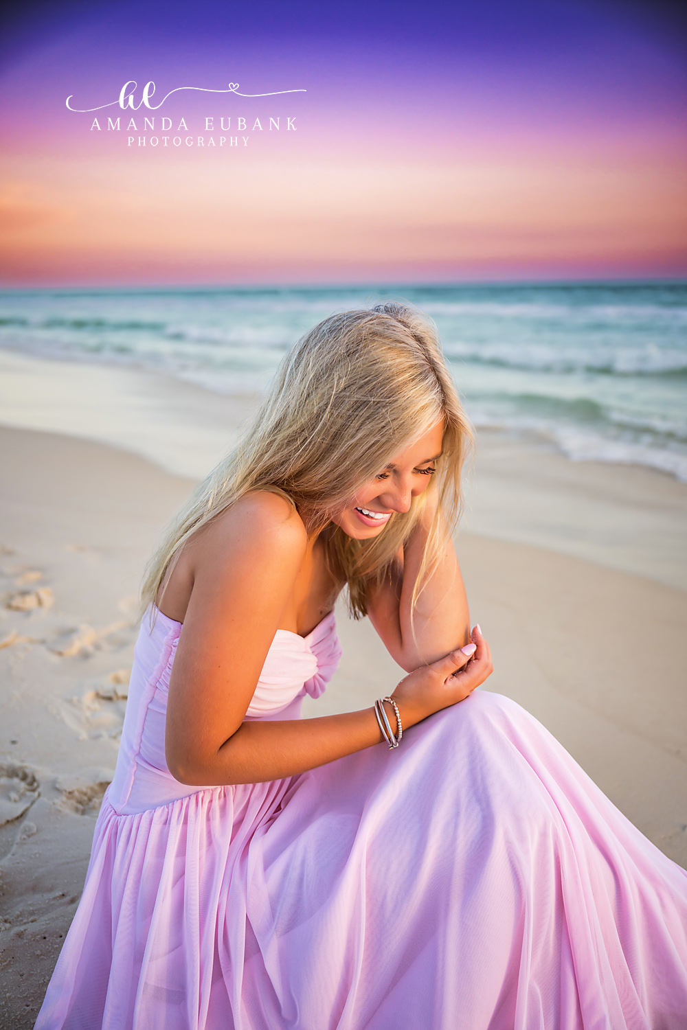 Lavender Gown at Twilight | Tampa Senior Photographer A senior in a lavender gown seated on the beach as twilight deepens during a senior portrait session in Tampa, Florida.