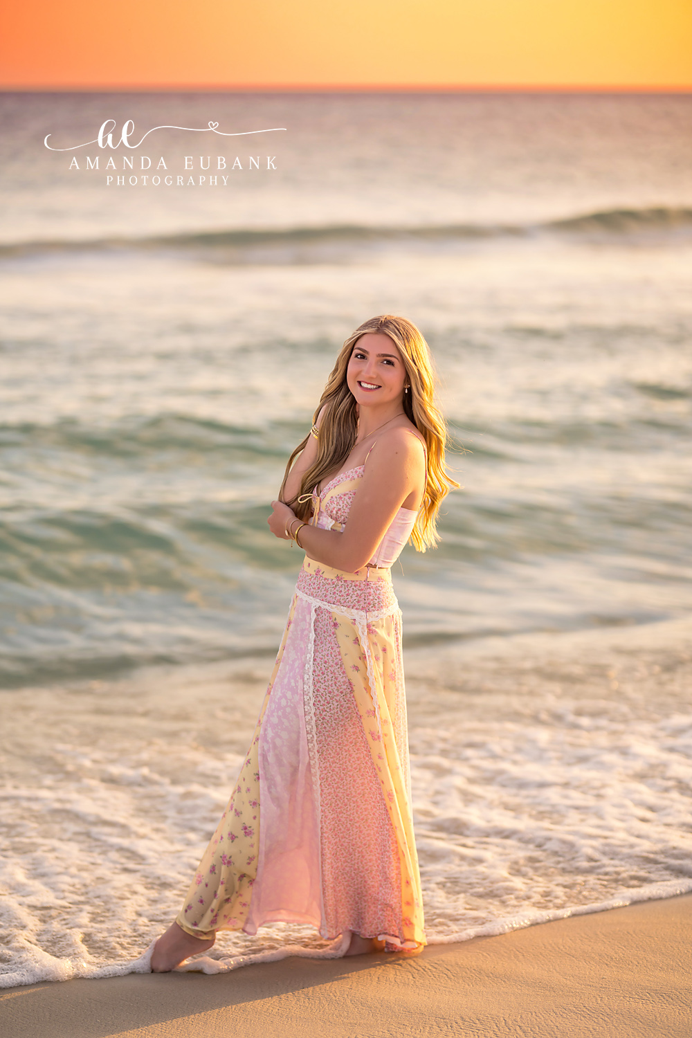Blush Gown on the Boardwalk | Beach Senior Session in Tampa, Florida Senior pictures in Tampa Bay showing a senior in a blush gown standing on a dune walkover at golden hour.