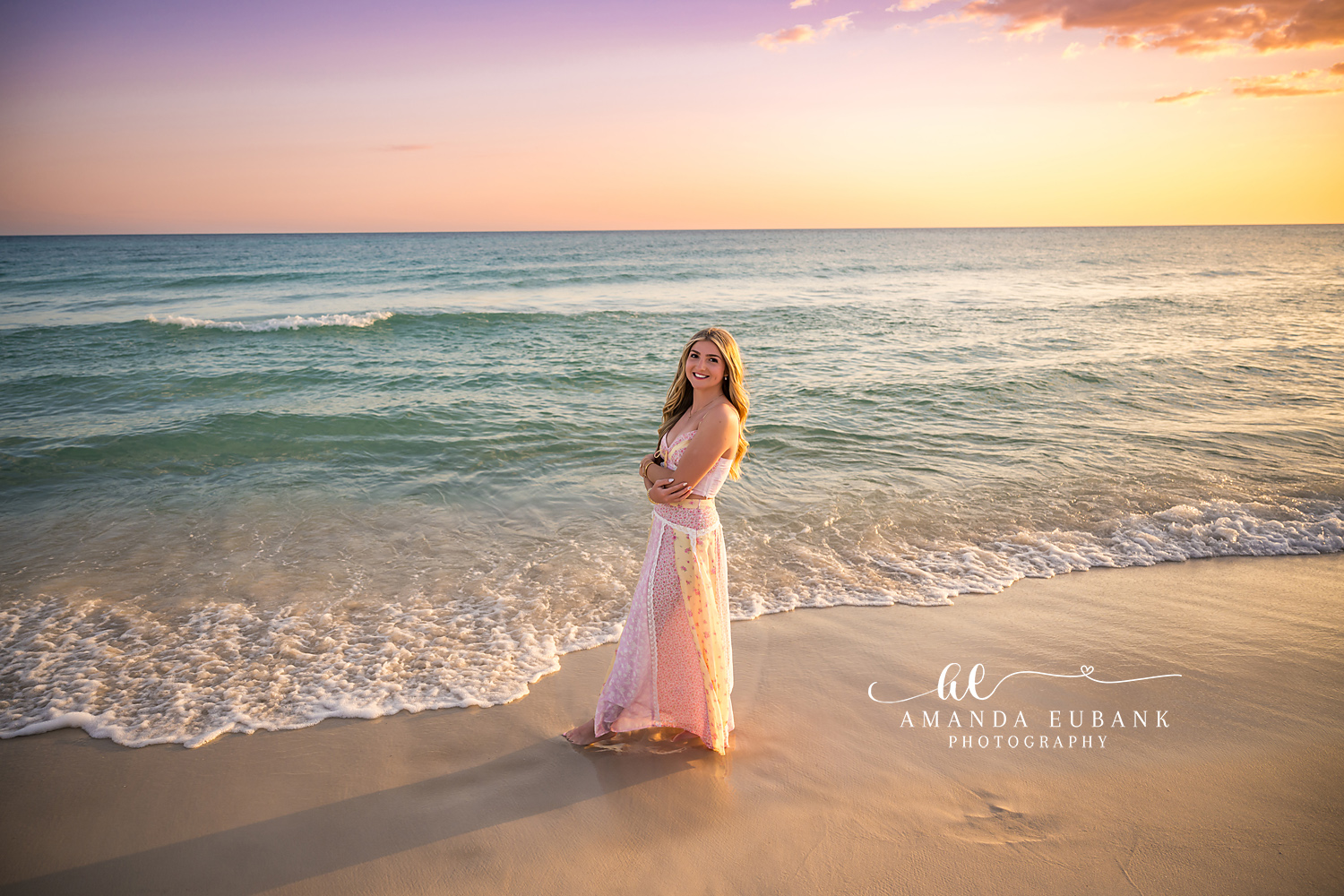 Blush Gown at the Water’s Edge | Tampa Senior Photographer A senior in a blush gown at the water's edge as the surf slides past during a senior portrait session in Tampa, Florida.