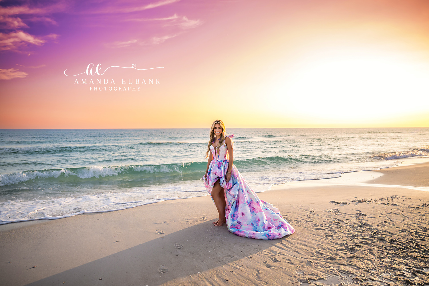 Printed Gown on Wet Sand | Tampa Senior Photographer A senior in a printed gown standing on mirror-wet sand under a purple sky during a senior portrait session in Tampa, Florida.
