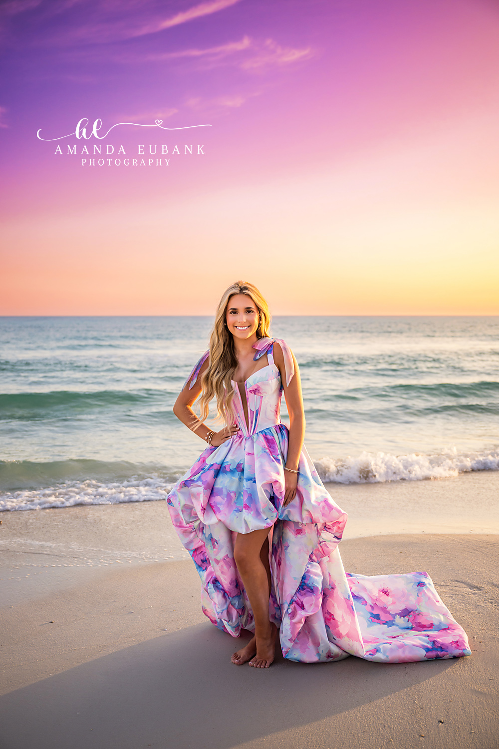 Printed Gown in Pastel Light | Tampa Senior Photographer A senior in a printed gown on the sand in soft pink and lavender light during a senior portrait session in Tampa, Florida.