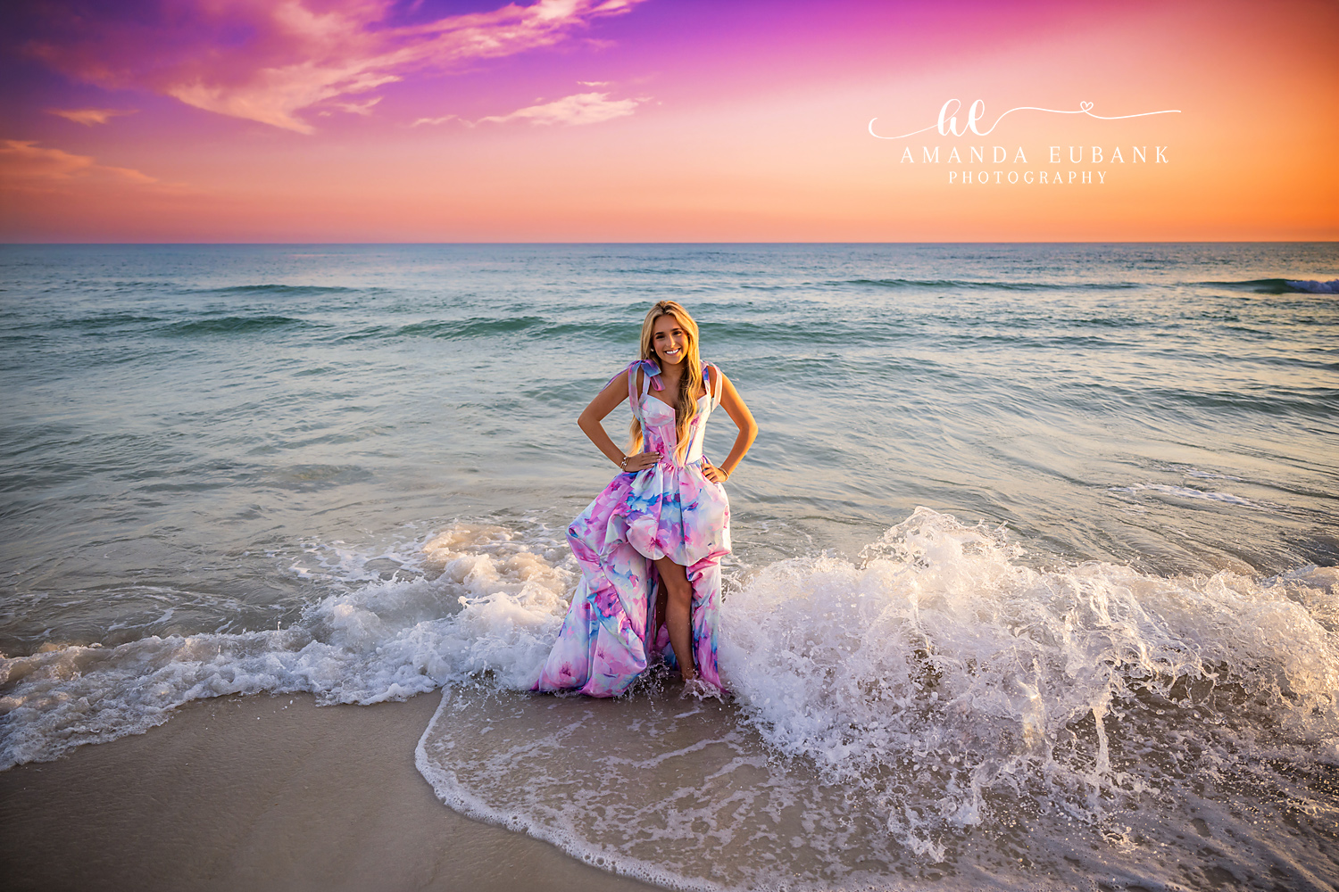 Seated in the Breaking Waves | Tampa Senior Photographer A senior in a printed gown seated as waves break white around her during a senior portrait session in Tampa, Florida.